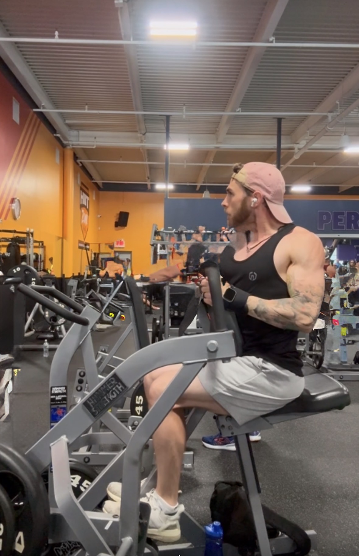 Coach D putting in work on a chest press machine