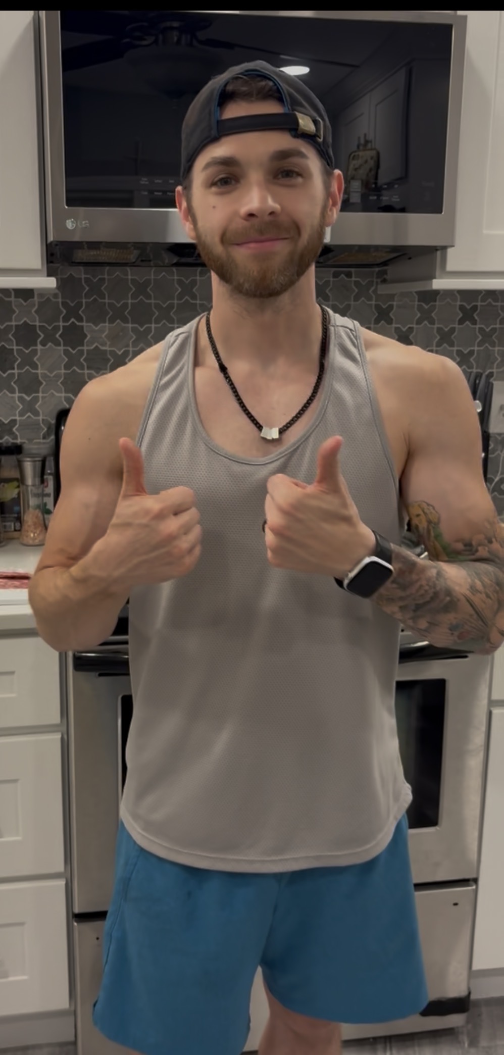 Coach D giving two thumbs up in his kitchen